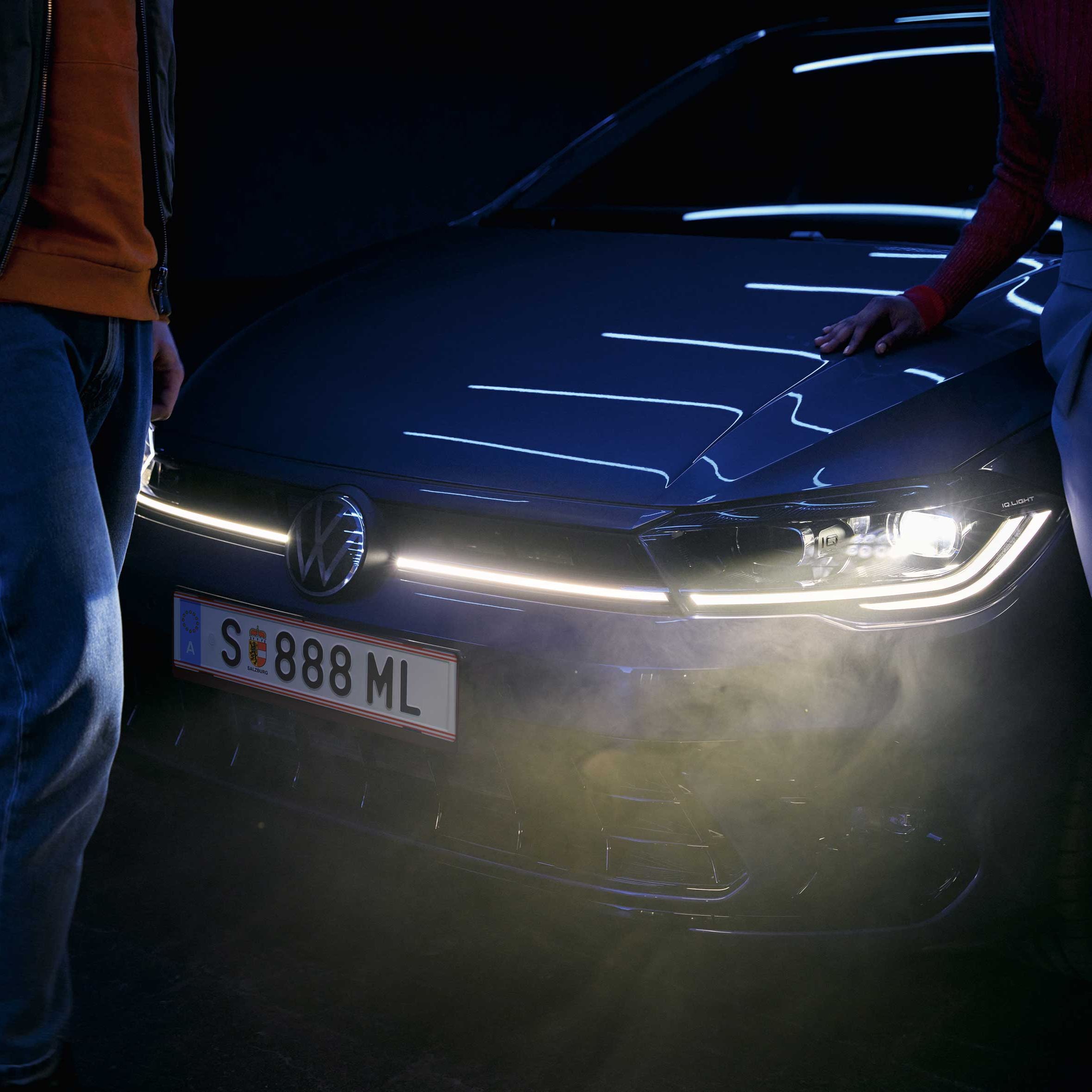 Ein VW Polo steht im Dunkeln mit aktiver Front-Lichtsignatur mit Nebel im Lichtschein.